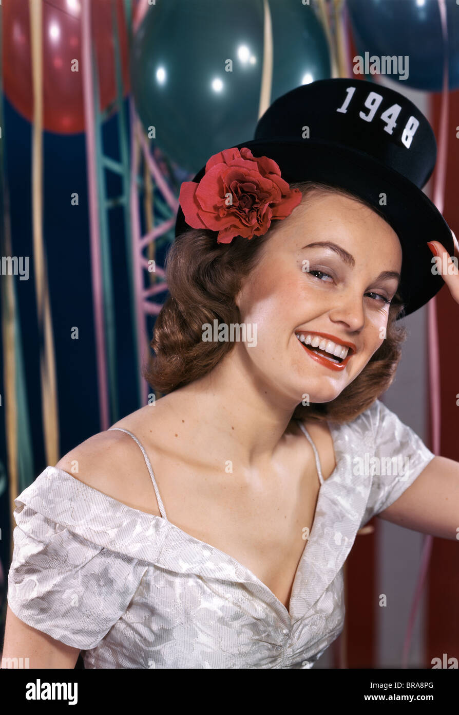 1940s SMILING WOMAN WEARING NEW YEARS EVE PARTY HAT OF 1948 Stock Photo