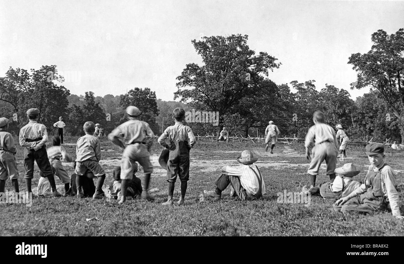 1900s 1910s 1920s GROUP OF BOYS PLAYING BASEBALL ON OUTDOOR FIELD