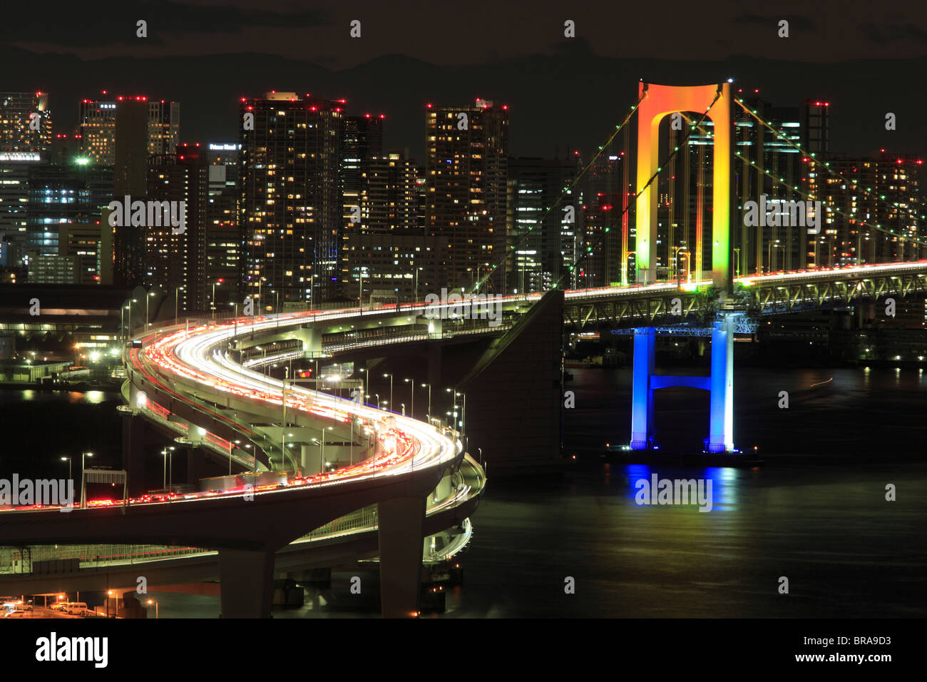 View of Tokyo downtown at night with Rainbow Bridge Stock Photo