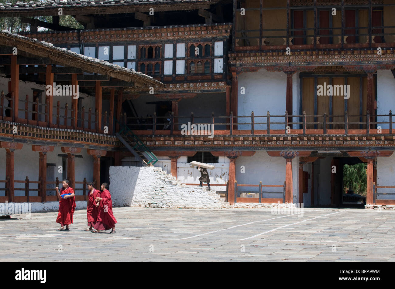 Monks walking in the court of the old Wangdue monastery, Bhutan, Asia Stock Photo