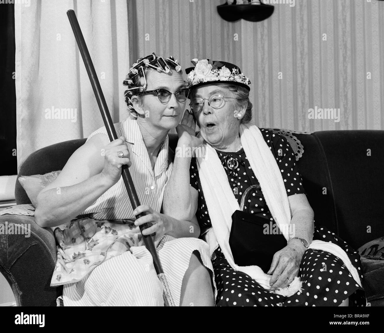 1950s 1960s Two Elderly Women Characters Gossiping One Woman With Hair Curlers Other With Hat Stock Photo Alamy