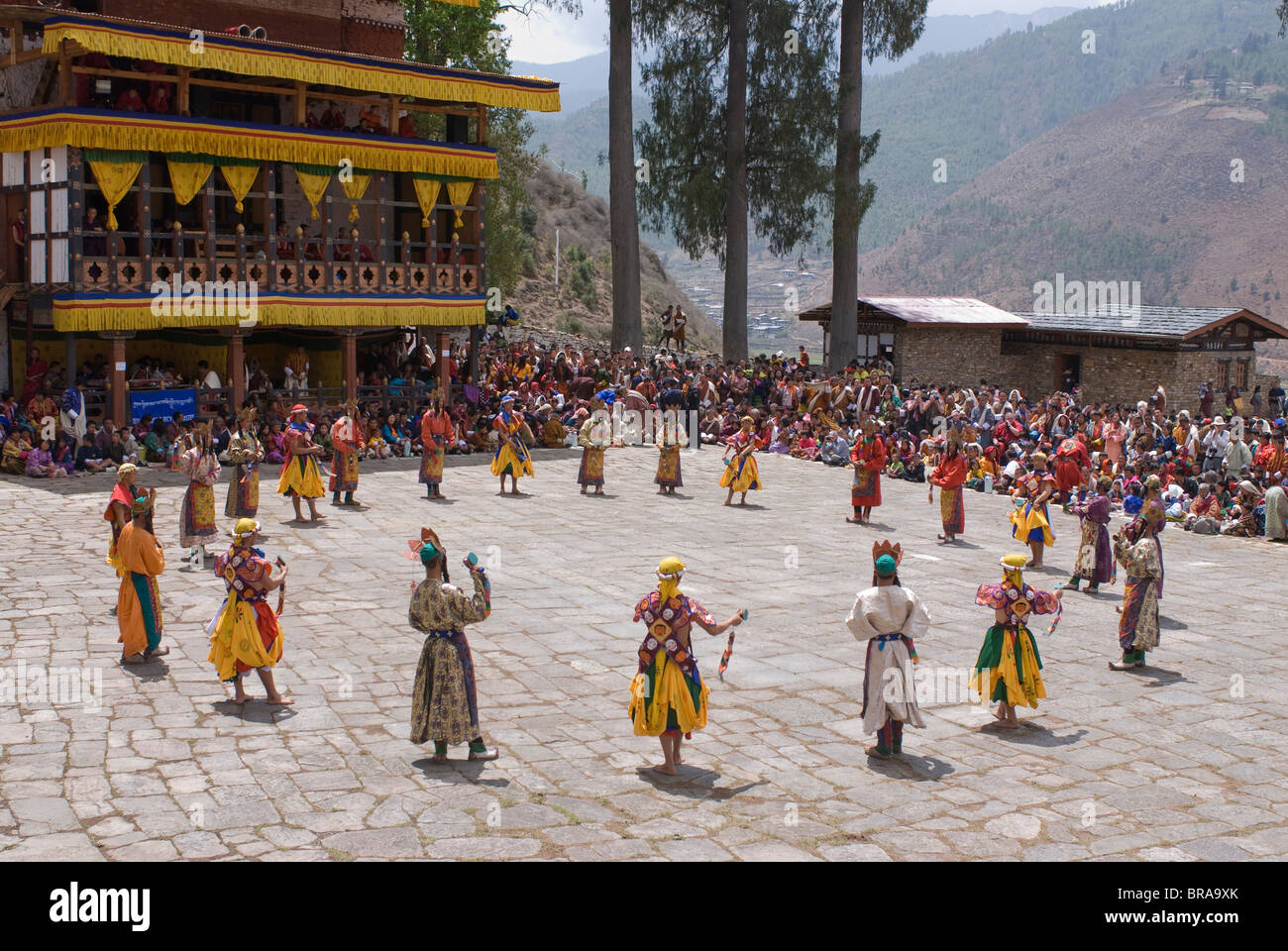 Costumed dancers at religious festival with many visitors, Paro Tsechu, Paro, Bhutan, Asia Stock Photo
