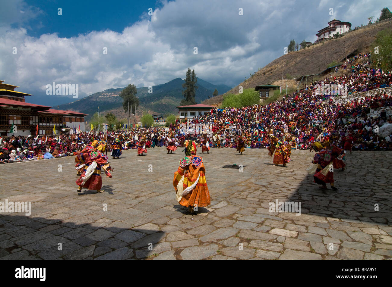 Costumed dancers at religious festival with many visitors, Paro Tsechu, Paro, Bhutan, Asia Stock Photo