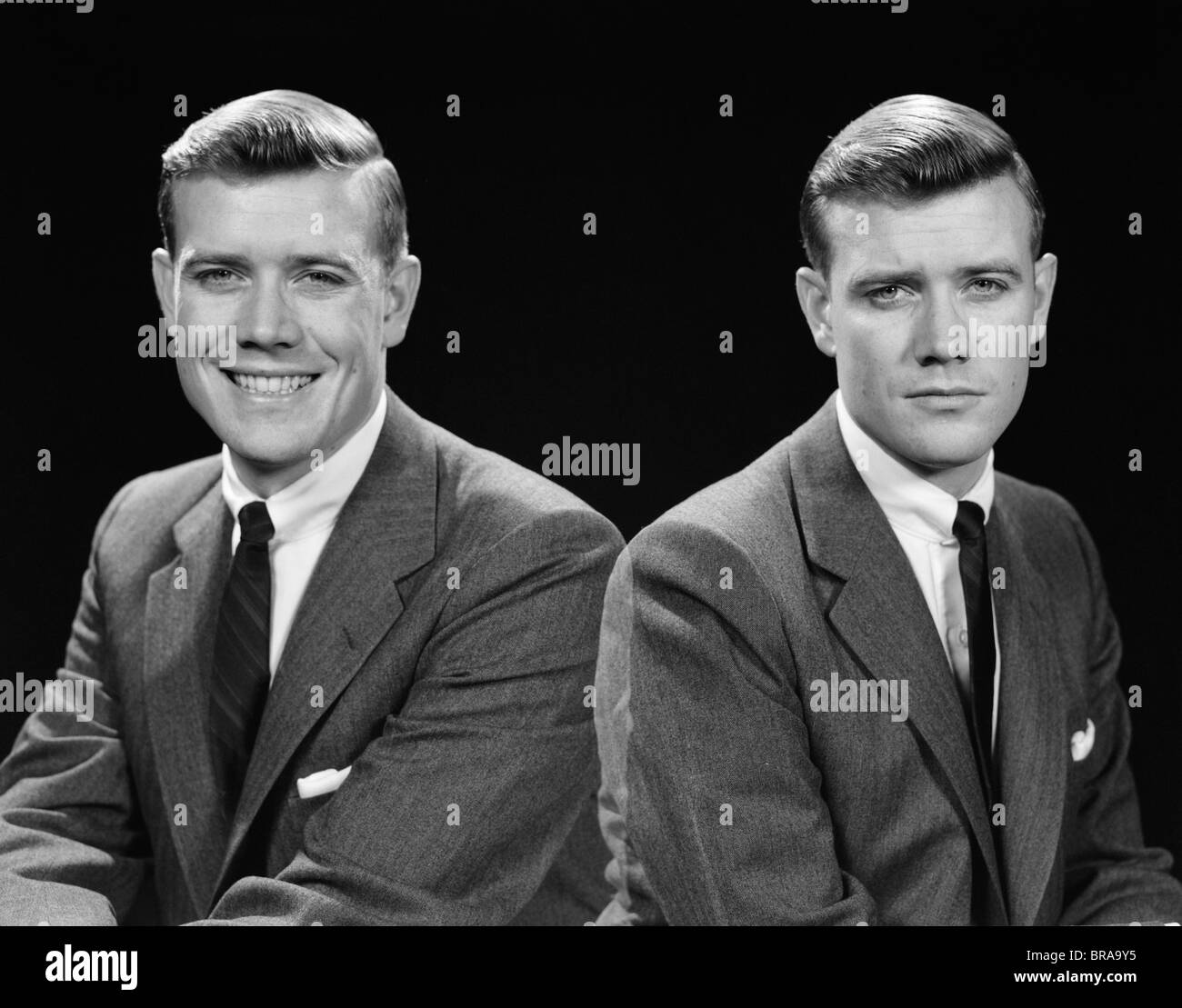 1950s DOUBLE EXPOSURE OF MAN WITH A SMILE AND A FROWN WEARING A SUIT Stock Photo