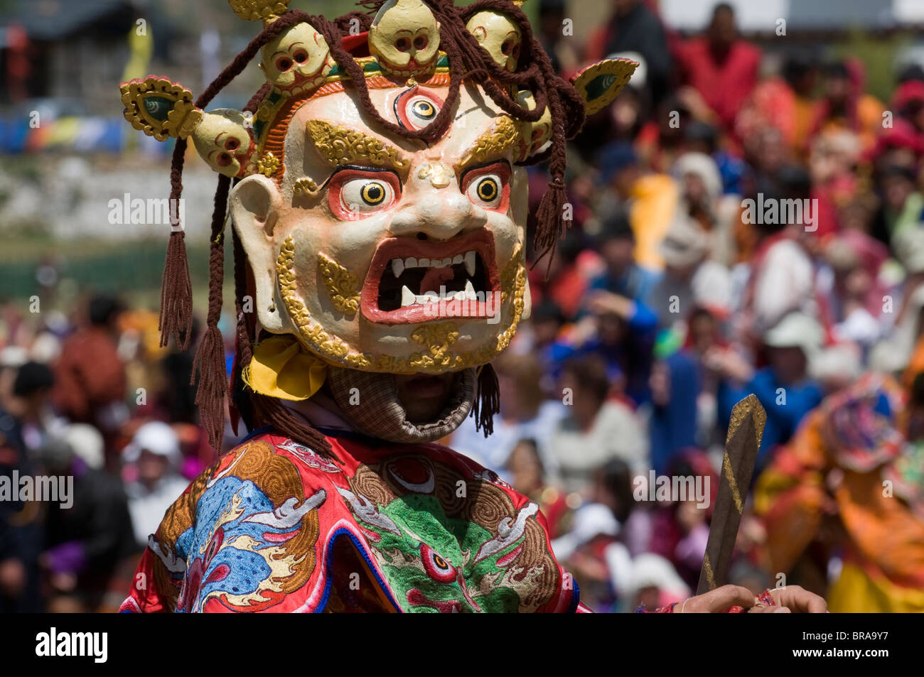 Masked dancer at religious festival with many visitors, Paro Tsechu, Paro, Bhutan, Asia Stock Photo