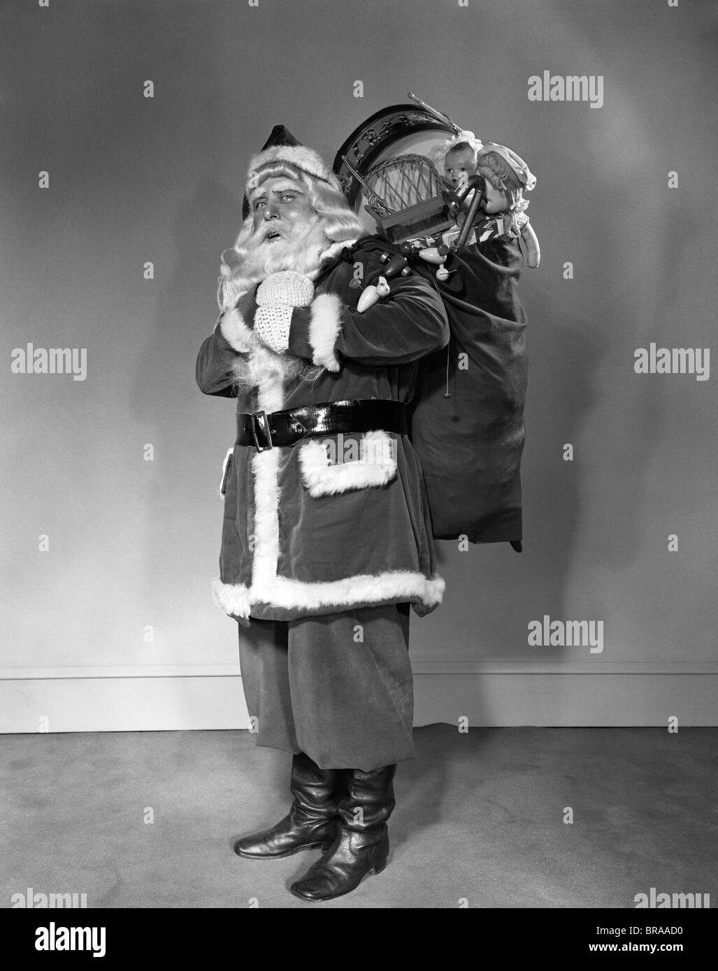 Santa claus carrying bag full Black and White Stock Photos & Images - Alamy