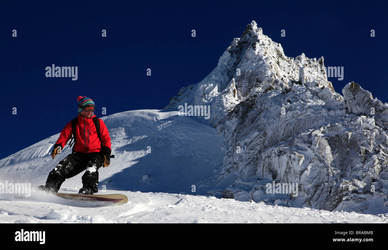 A snowboarder riding powder snow off the Grand Montets ski area, Chamonix  Valley, Haute Savoie, French Alps, France Stock Photo - Alamy