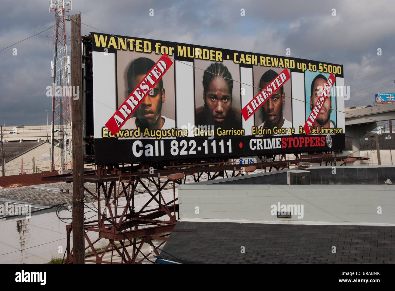 A billboard on Interstate 10 in New Orleans shows the latest 'most wanted' criminals in the New Orleans area. Stock Photo