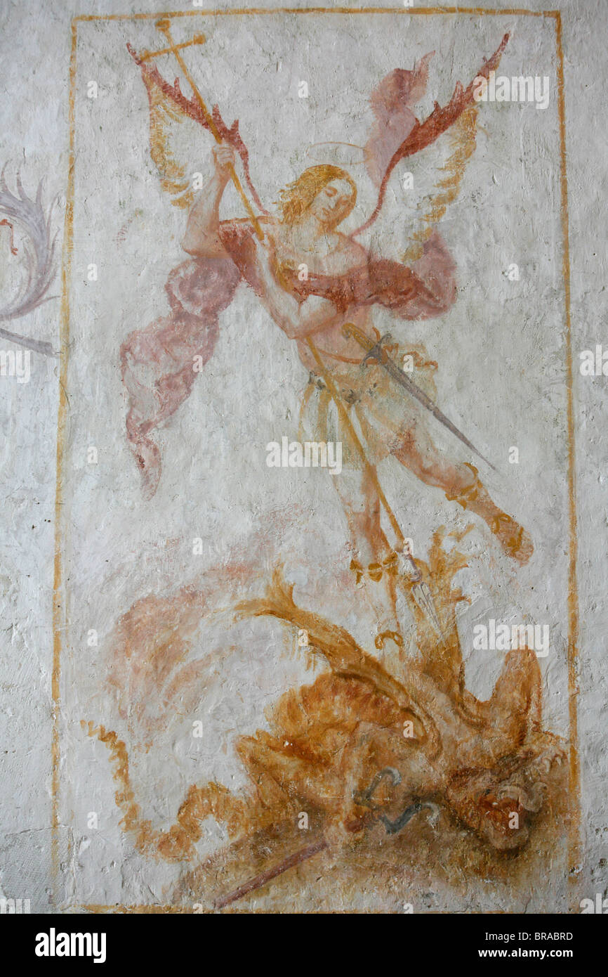 A 15th century fresco depicting St. Michael slaying a dragon, La Ferte Loupiere, Yonne, France, Europe Stock Photo
