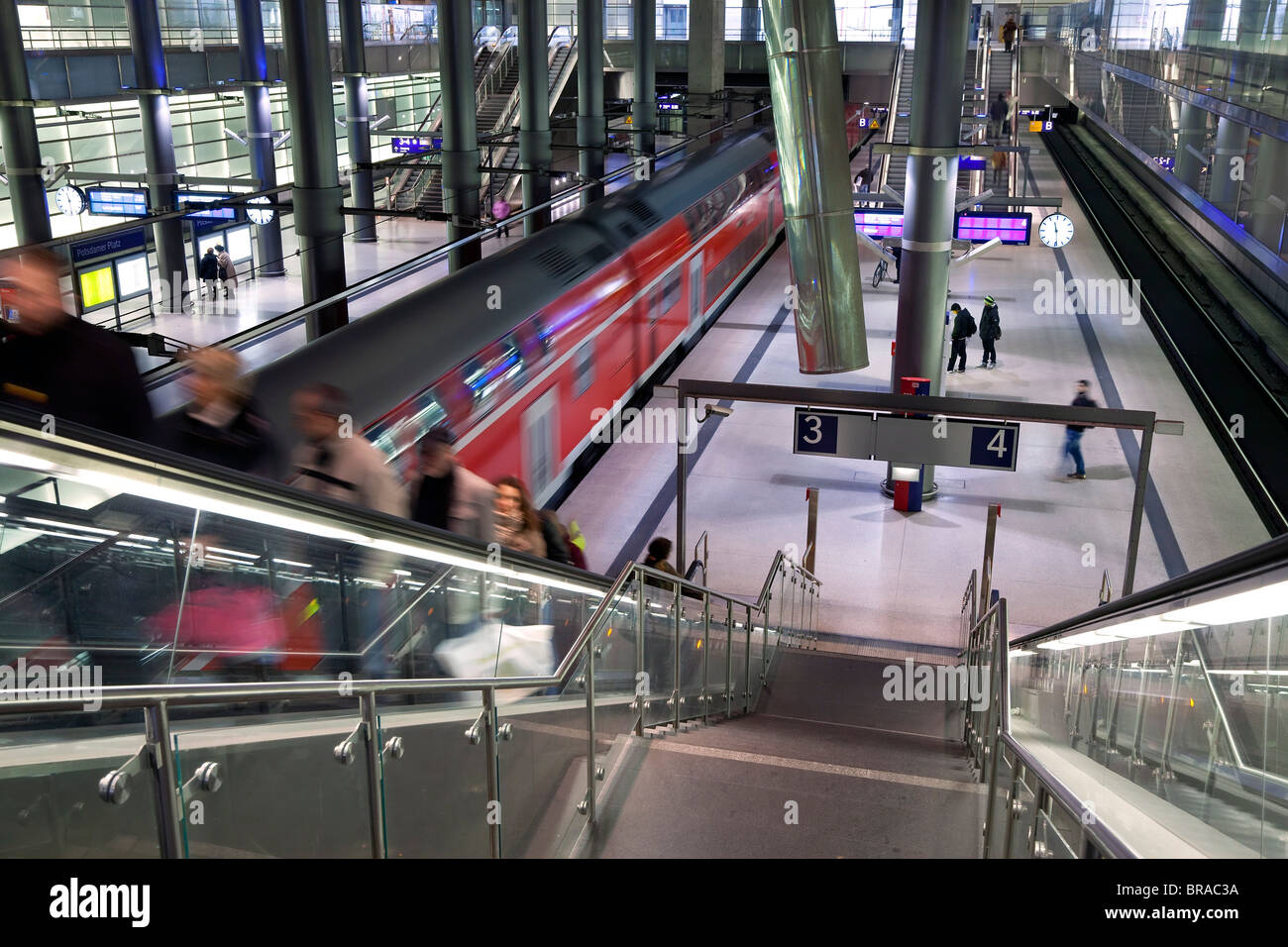 Moving train pulling into modern train station, Berlin, Germany, Europe Stock Photo
