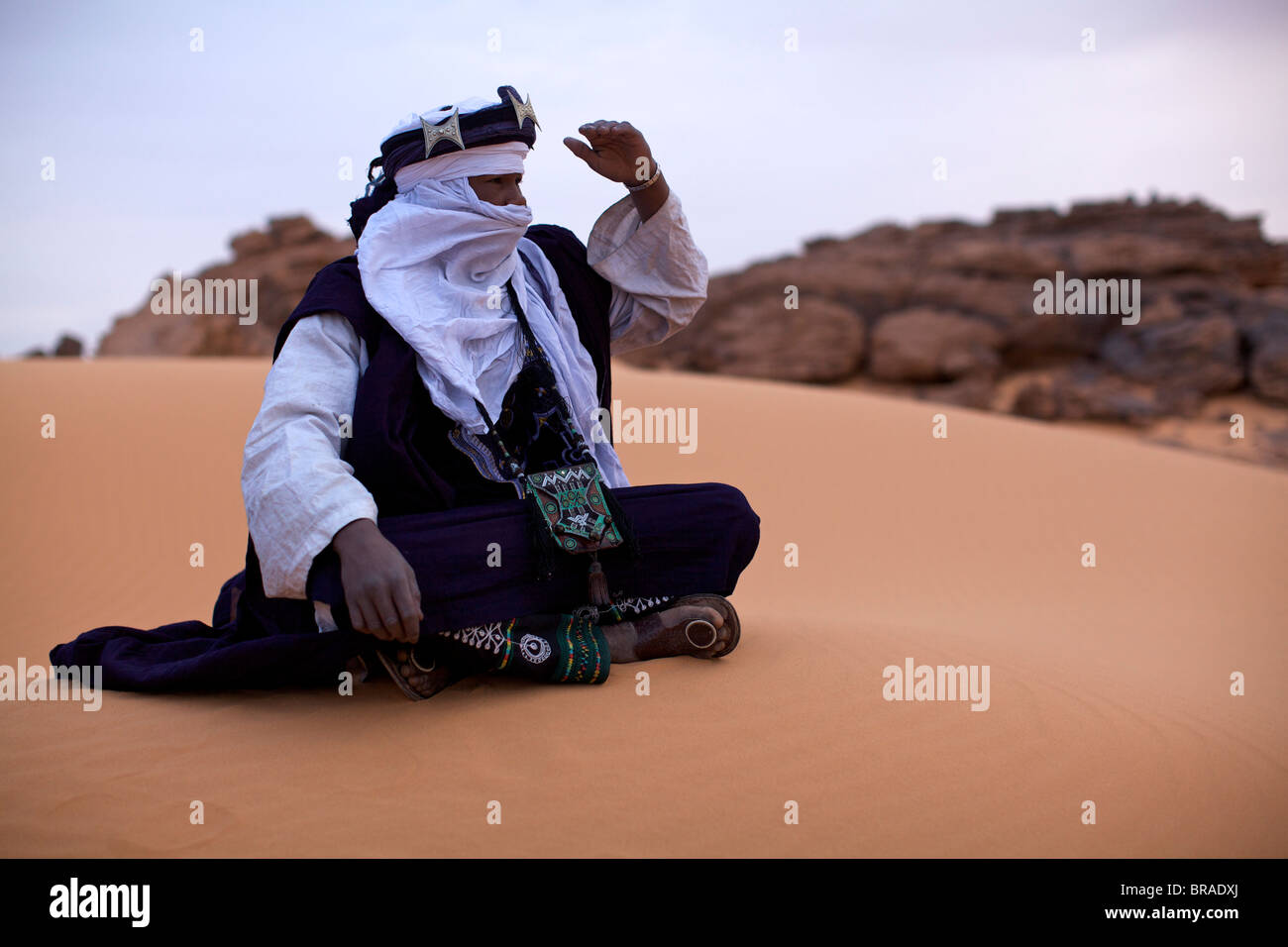 A Tuareg dressed for celebrations at the entrance of the Dar Sahara tented camp in the Fezzan desert, Libya, North Africa Stock Photo