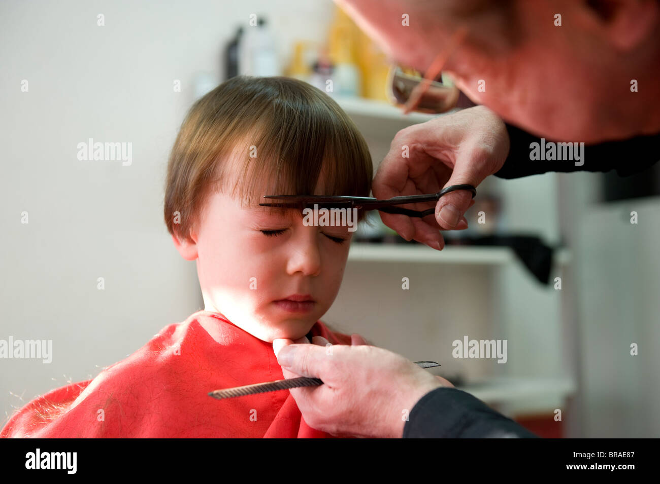 5 Year Old Having A Haircut In A Barbers Salon In North Yorkshire