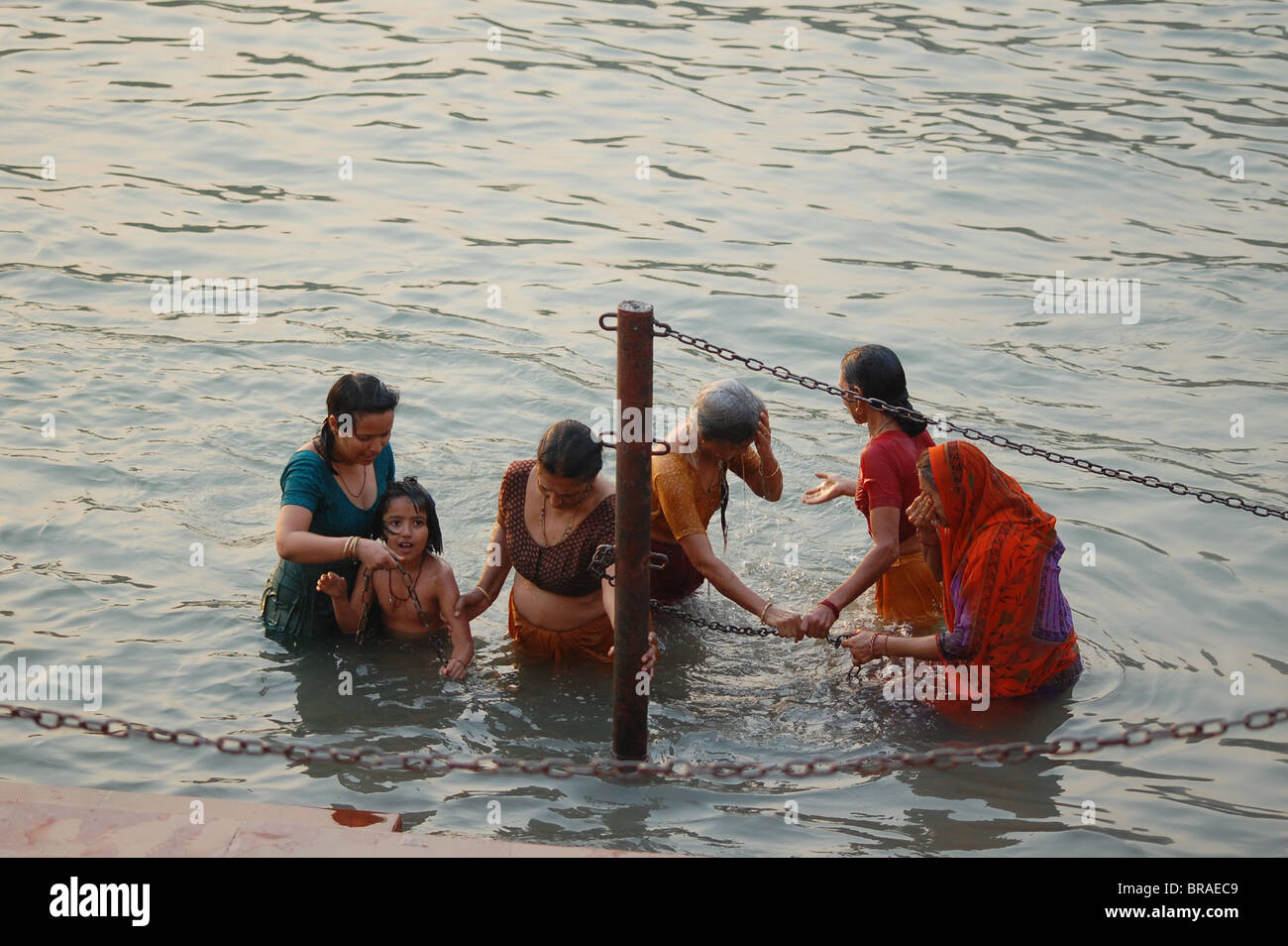 women bathing in holy river Ganges in India during Kumbh Mela festival Stock Photo