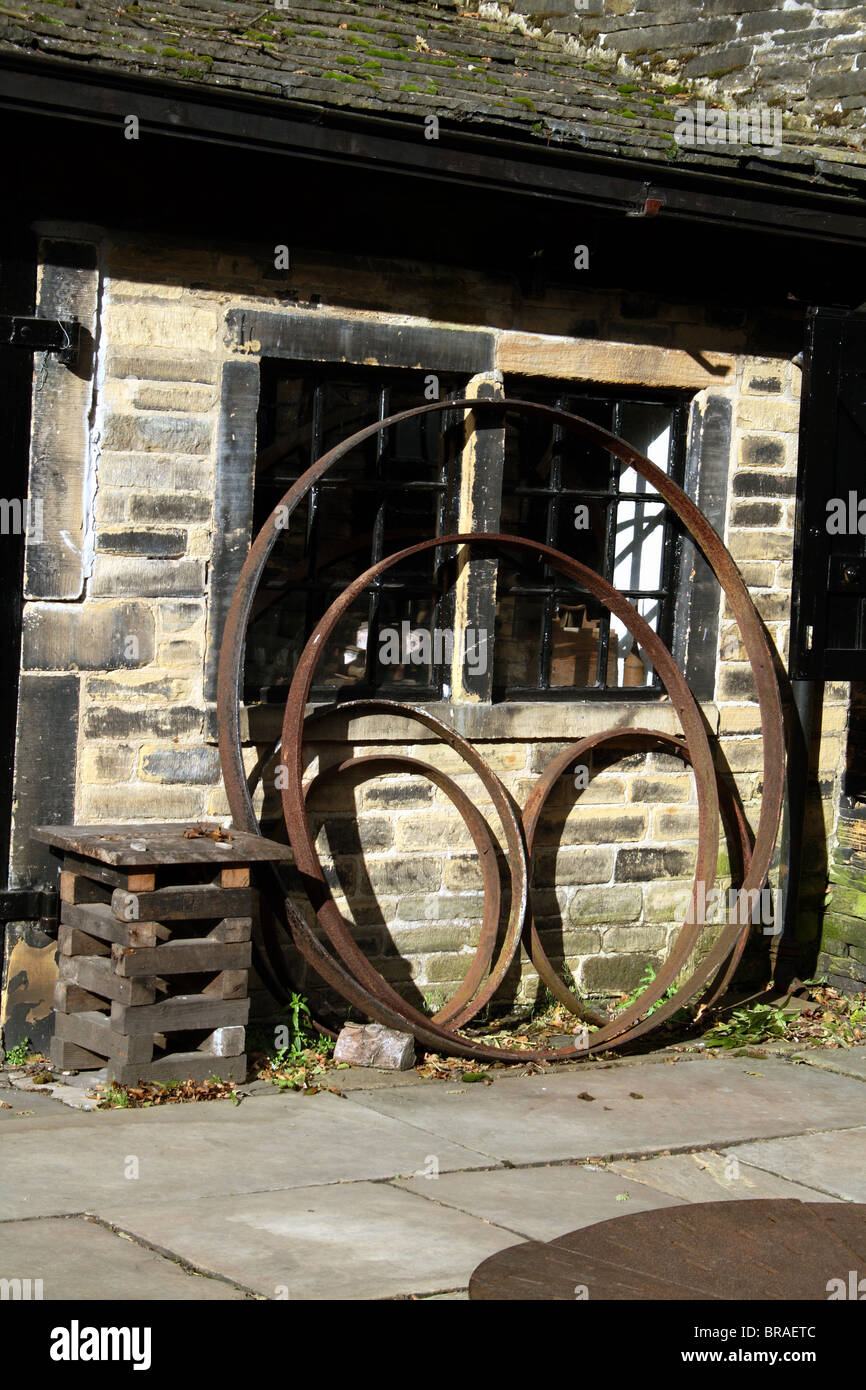 Cart Wheels of Various Sizes outside a wheelwright Shibden Hall Halifax Yorkshire United Kingdom UK Stock Photo