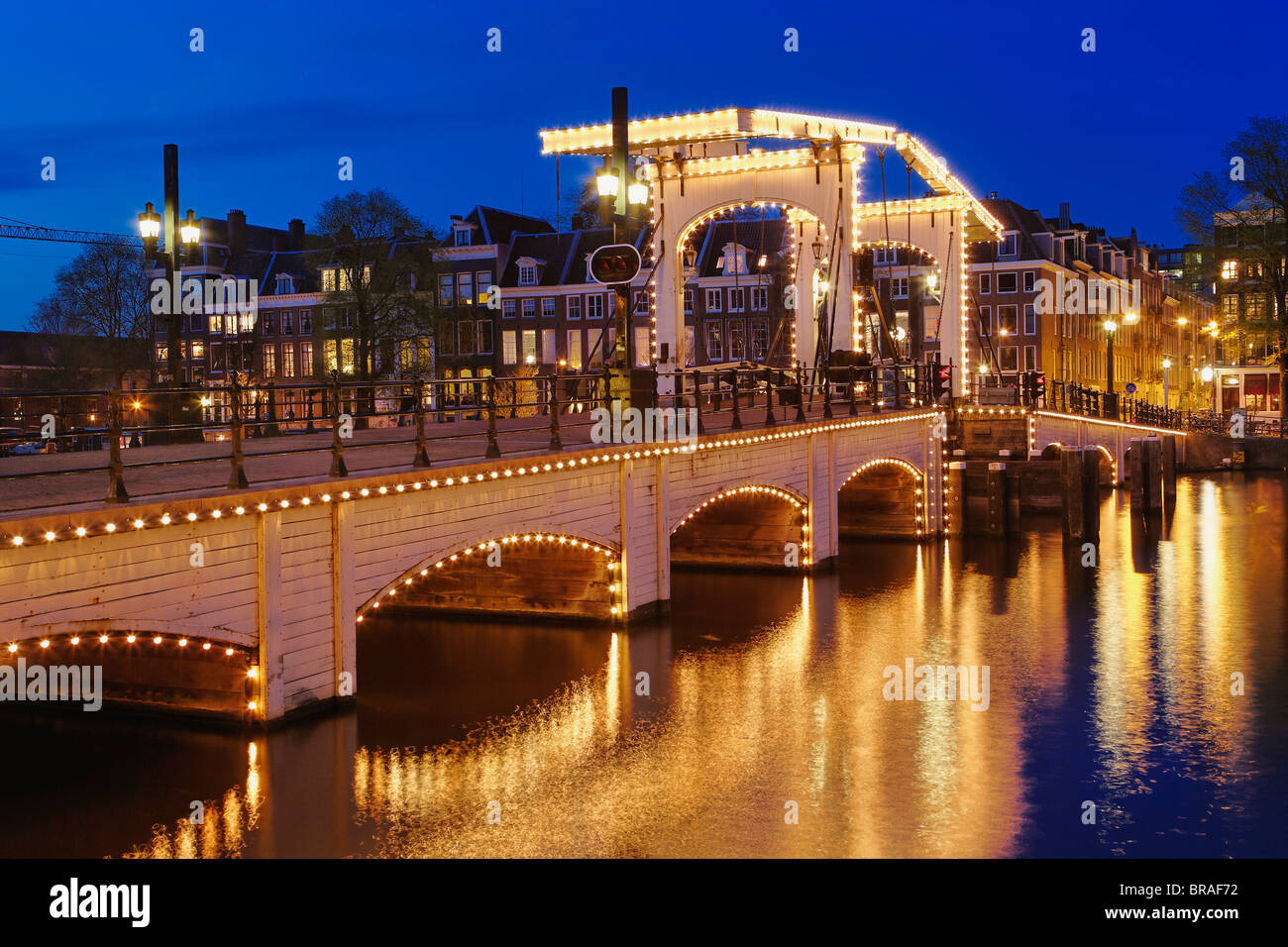 Dusk view of Magere Brug or Skinny Bridge and Amstel River; Netherlands, Holland Stock Photo