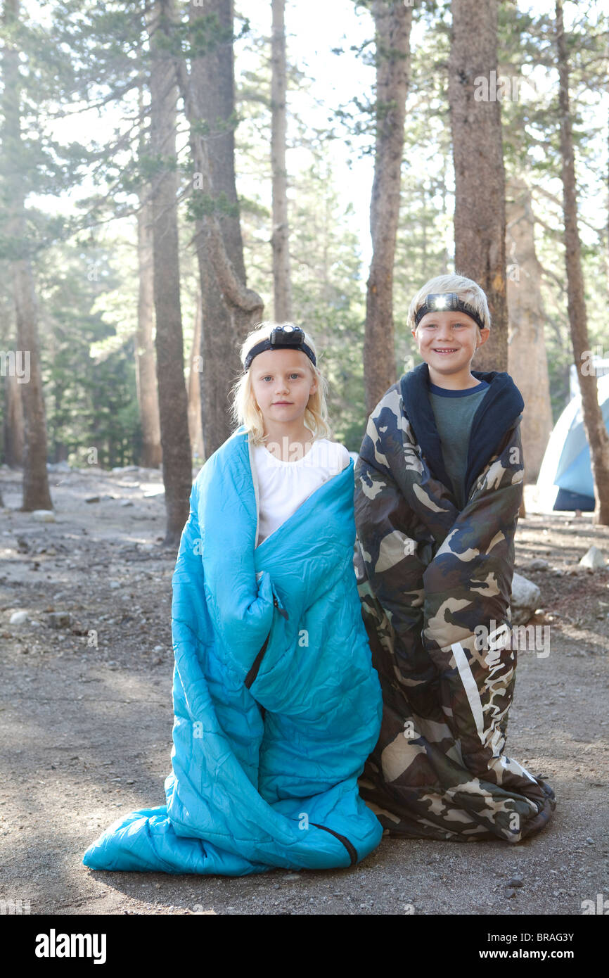 Boy and girl in sleeping bags Stock Photo