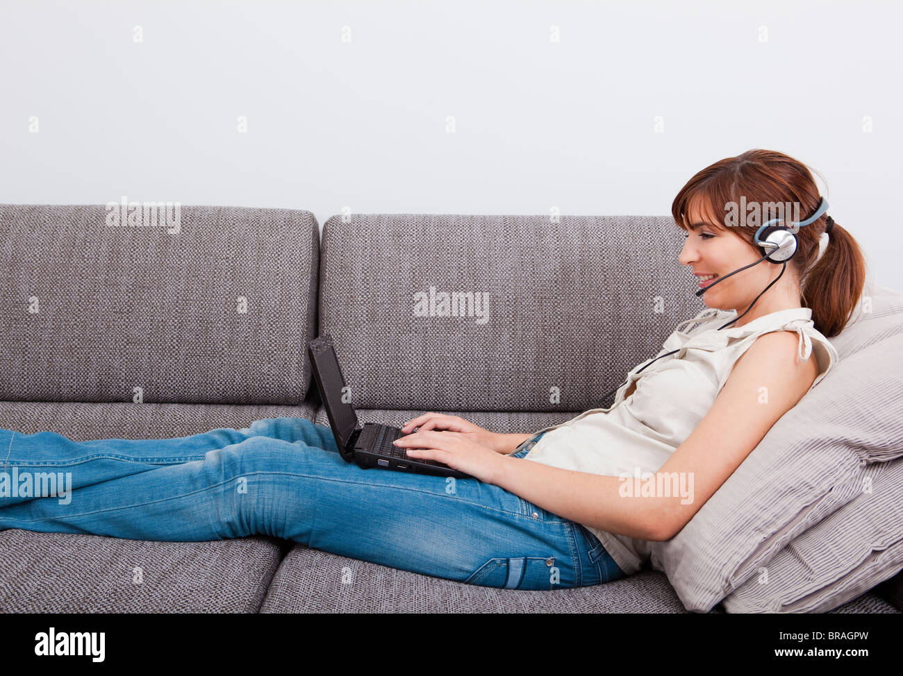 Beautiful young woman at home with a laptop and speaking over the ...
