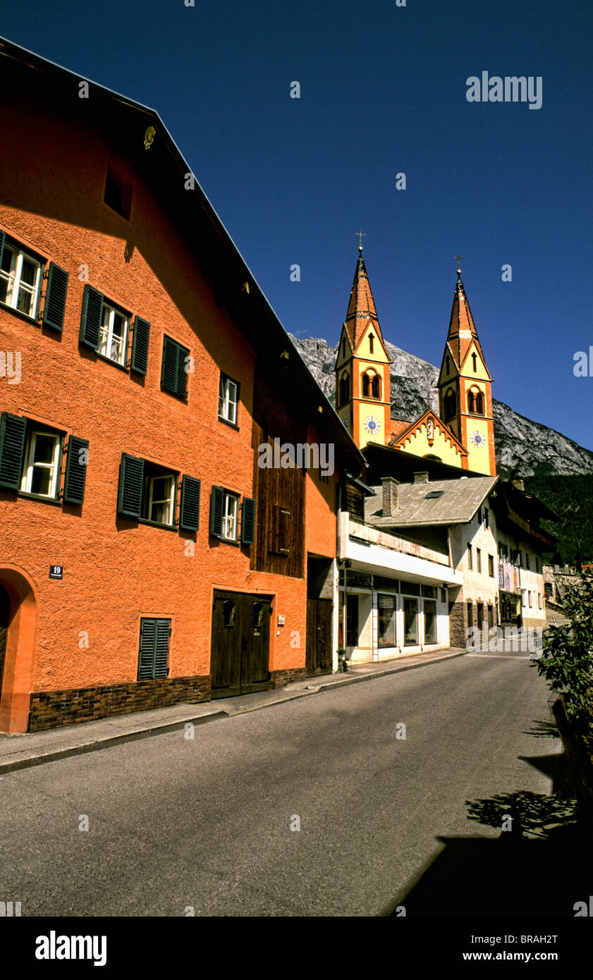 Street leading to Peter and Paul Catholic Church color in Telfs Austria near Innsbruck Stock Photo