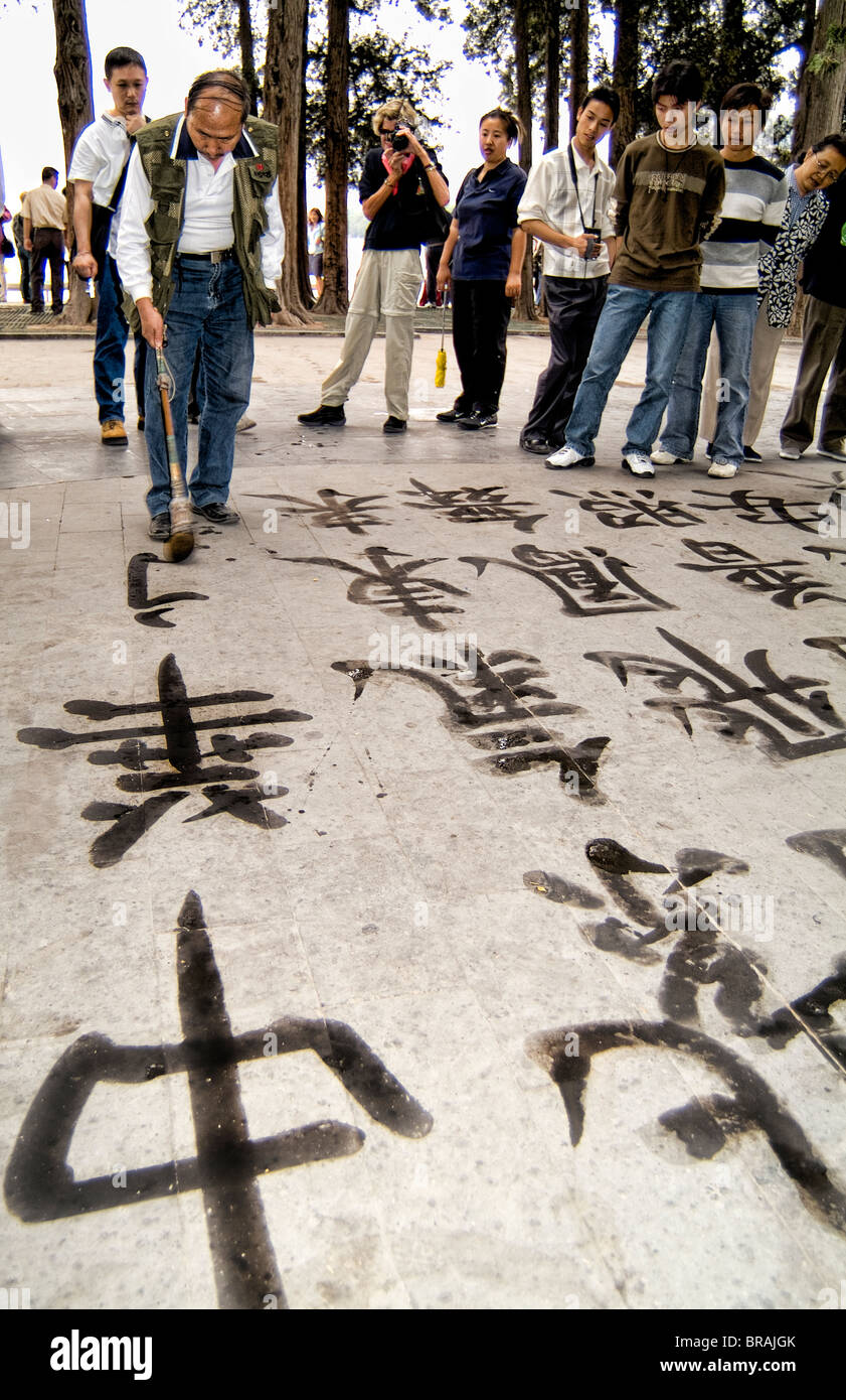 China Beijing man in park practicing writing Chinese Calligraphy in Beijing China Stock Photo