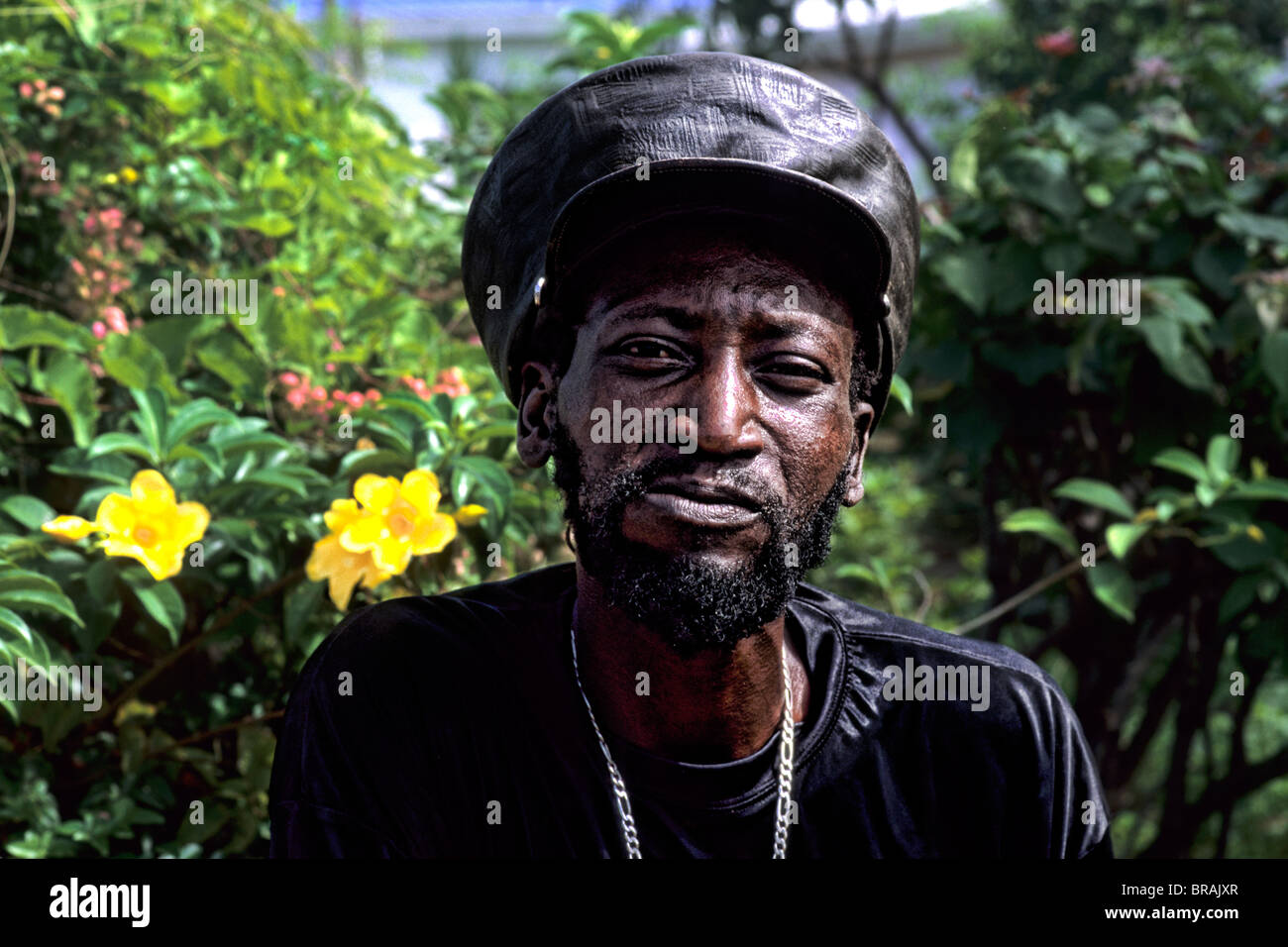 Reggae native man with hat in colorful gardens near St John Antigua ...