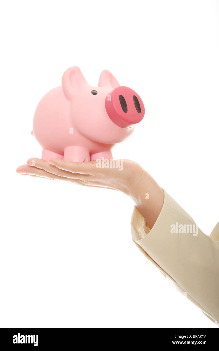 A woman hand holding a piggy bank. Isolated on white Stock Photo - Alamy