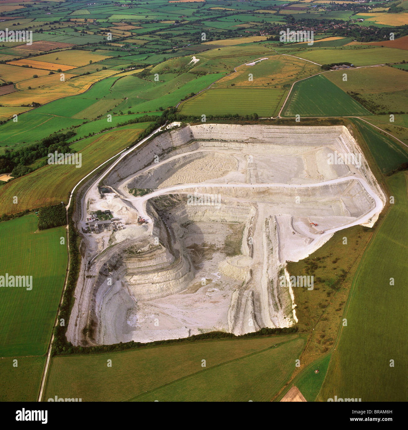 Aerial image of Westbury chalk quarry, with Westbury White Horse and Bratton Camp Hill Fort in background, Wiltshire, UK Stock Photo