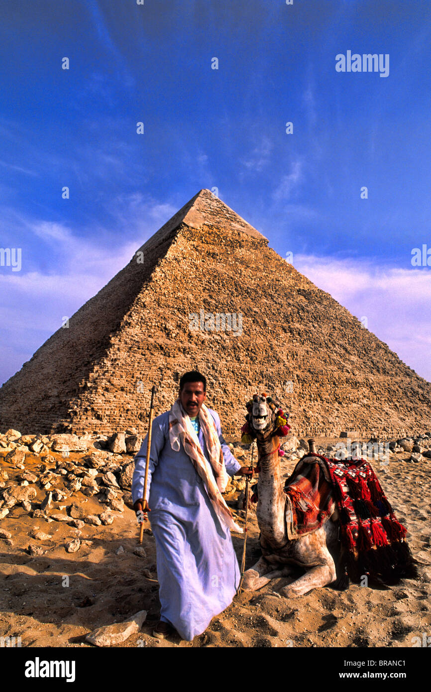 Camel and local camel rider for tourists in front of the famous Great Pyramids of Giza Egypt Stock Photo