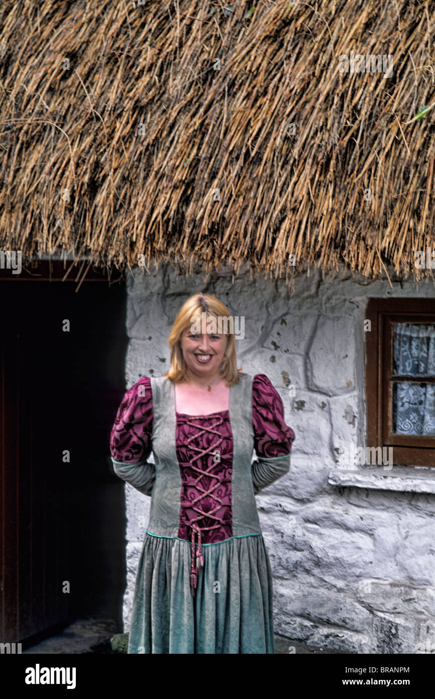 Life in Ireland woman in traditional dress for tourists at Bunratty Castle grounds in Ennis Ireland Stock Photo