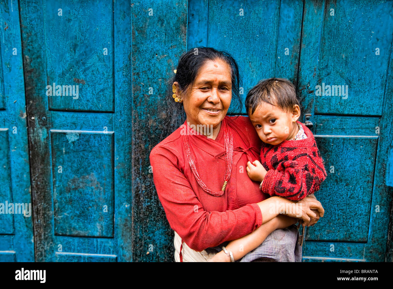 Woman local with grand child in arms in village of Bhaktapur a town near Kathmandu Nepal Stock Photo