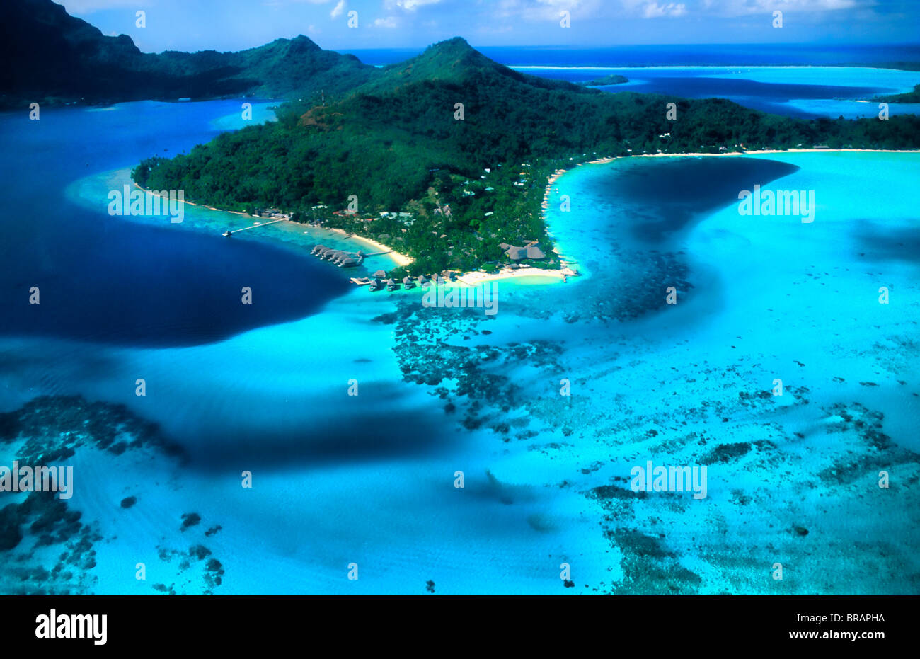 Aerial of the green water and clear blue colors of the islands of Bora
