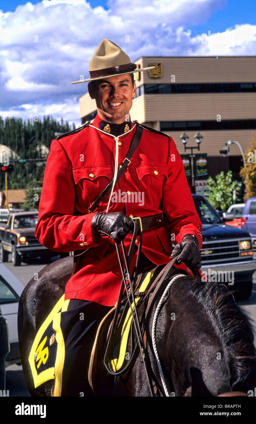 Royal Canadian Mounted Policeman on horse in uniform in Whitehorse Yukon Canada Stock Photo