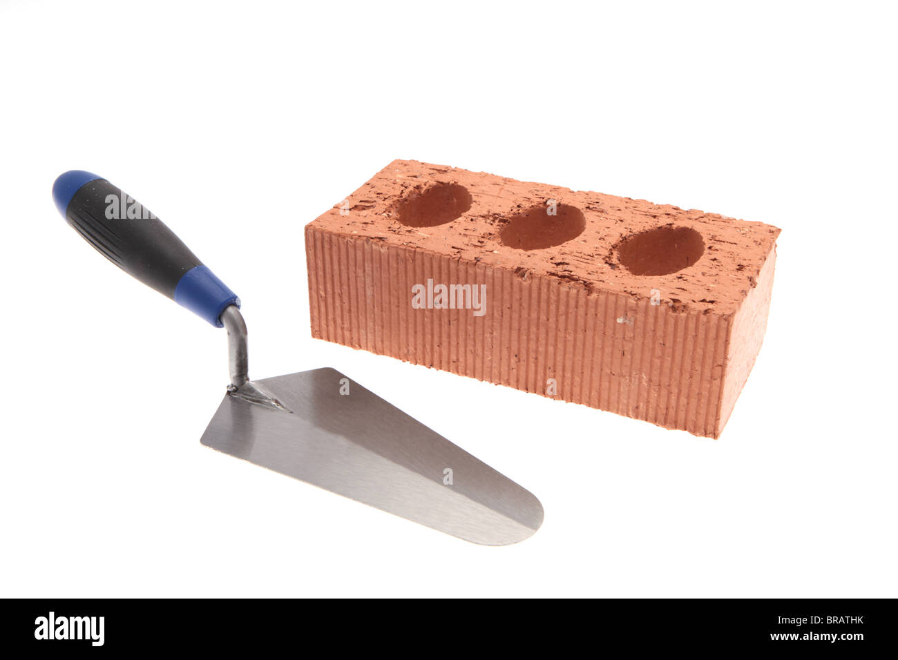 New red brick and gauging trowel isolated against a white background Stock Photo