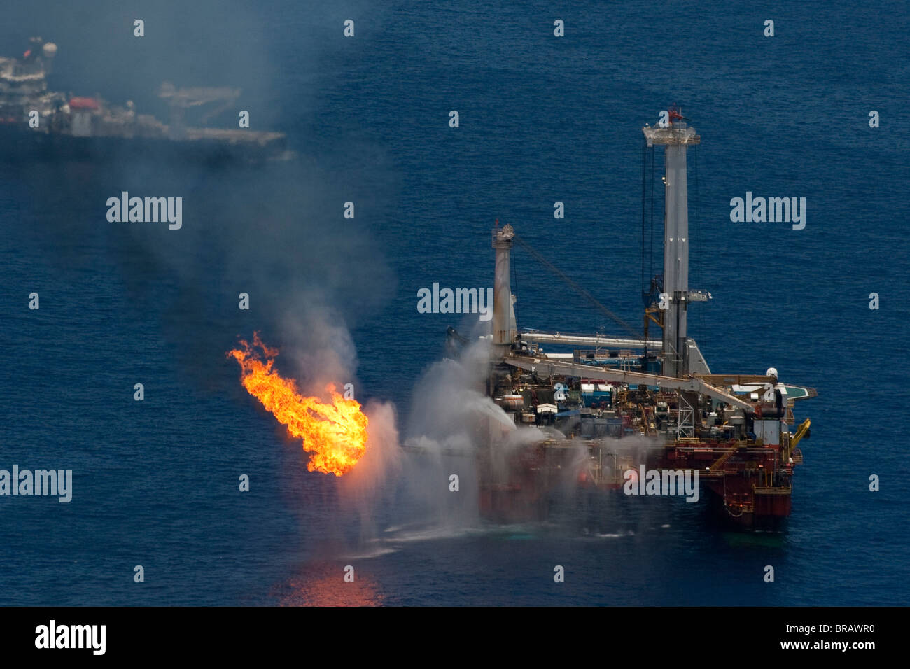Drilling ships at the site of the BP Deepwater Horizon oil spill in the Gulf of Mexico recover oil and flare off gas. Stock Photo