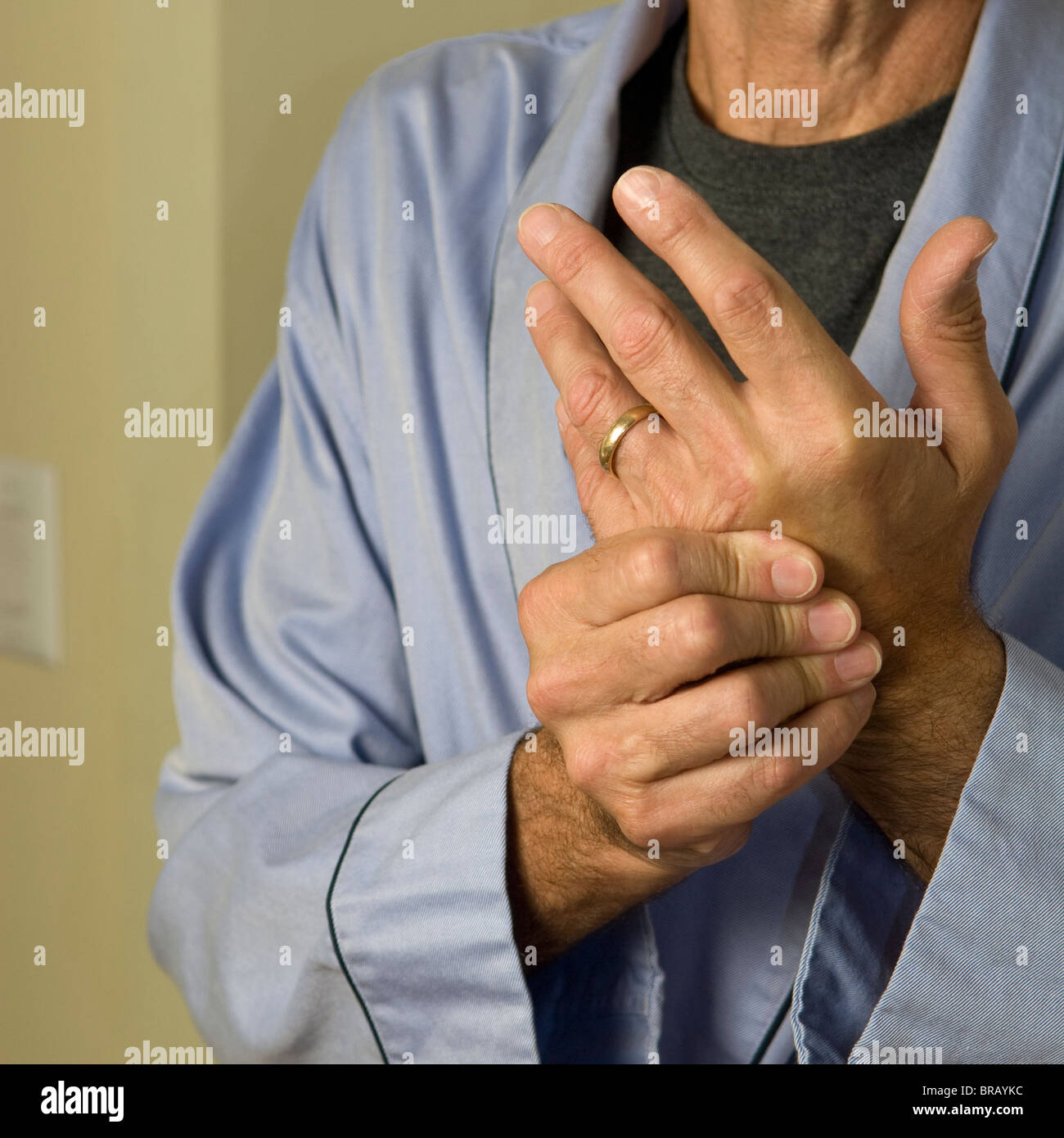 man wearing bathrobe wringing hands Stock Photo