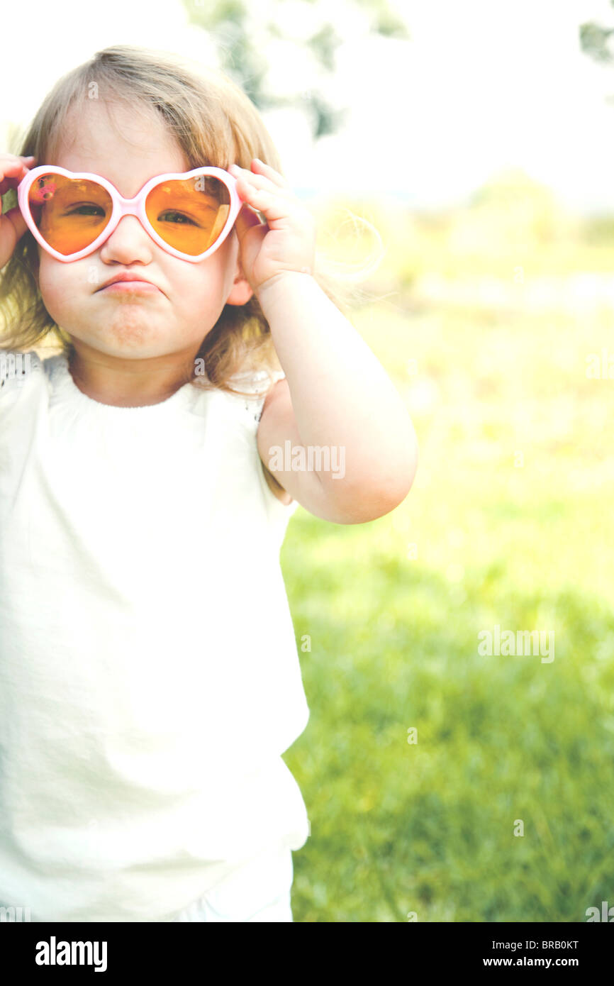 Young girl in heart shaped sunglasses Stock Photo Alamy