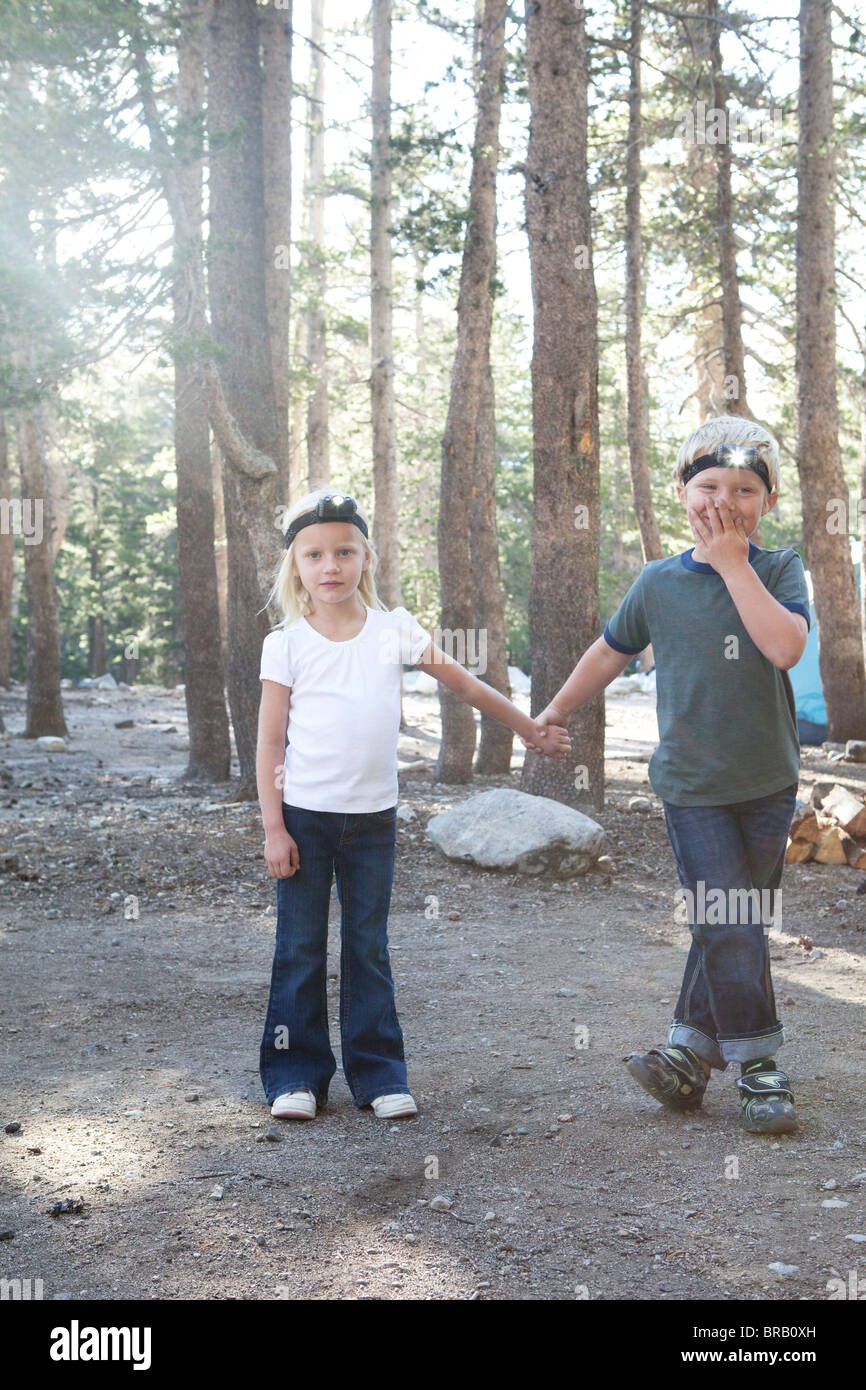Boy and girl in woods with headlamps Stock Photo