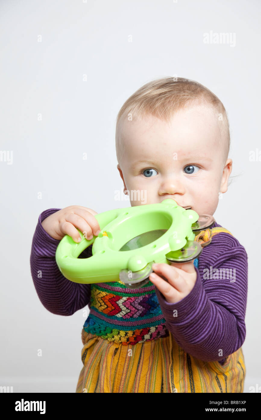 Blond baby boy with musical toy at home. Photo:Jeff Gilbert Stock Photo