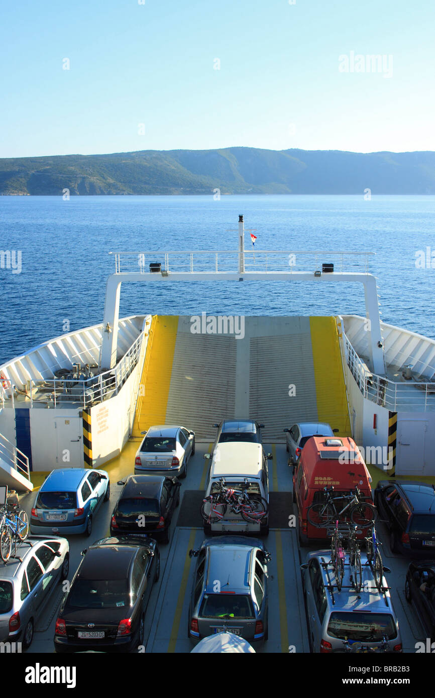 A ferry with passenger cars heading toward Merang on Cres Island, Croatia Stock Photo