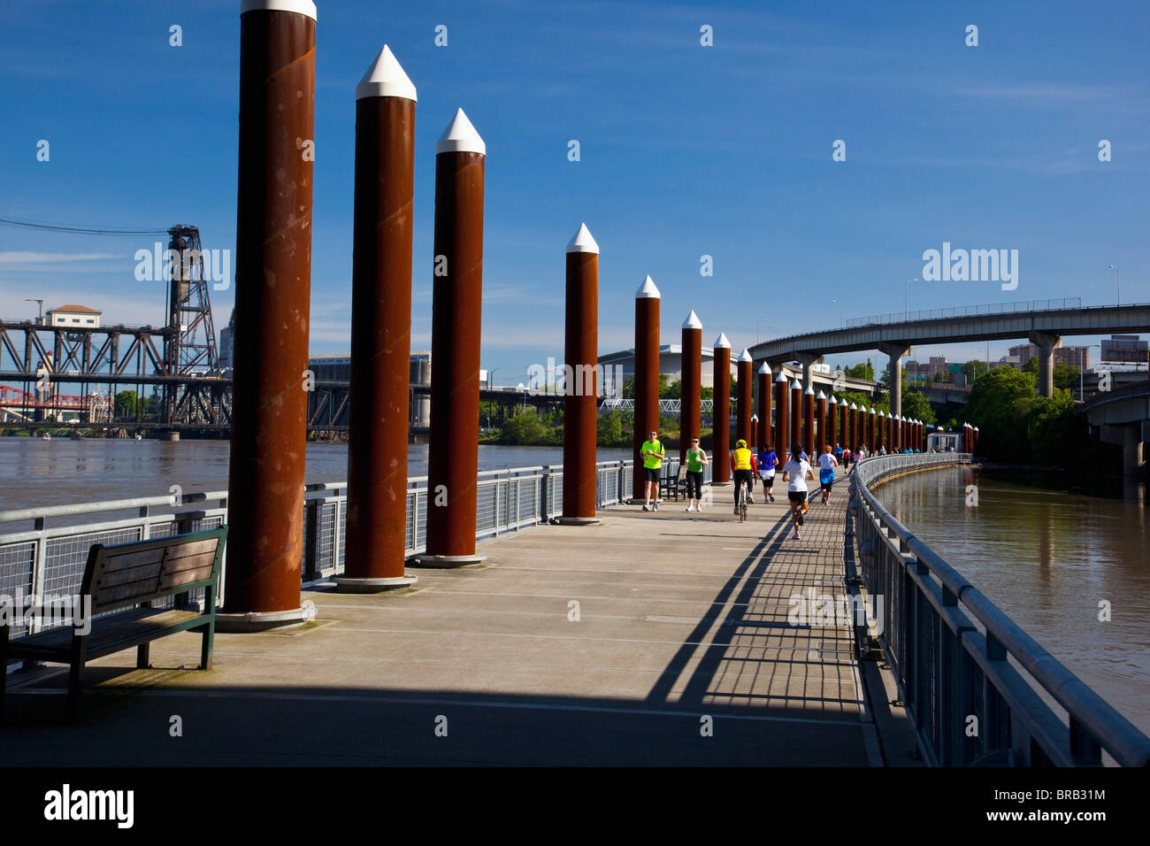 People Running, Cycling And Walking Over A Bridge On The Willamette River; Portland, Oregon, United States Of America Stock Photo