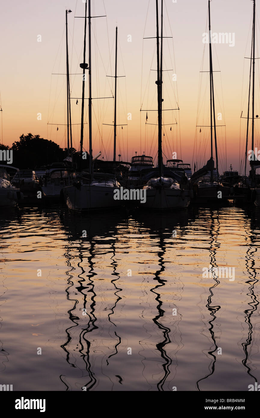 Sailing boats in Marina at sunset Stock Photo