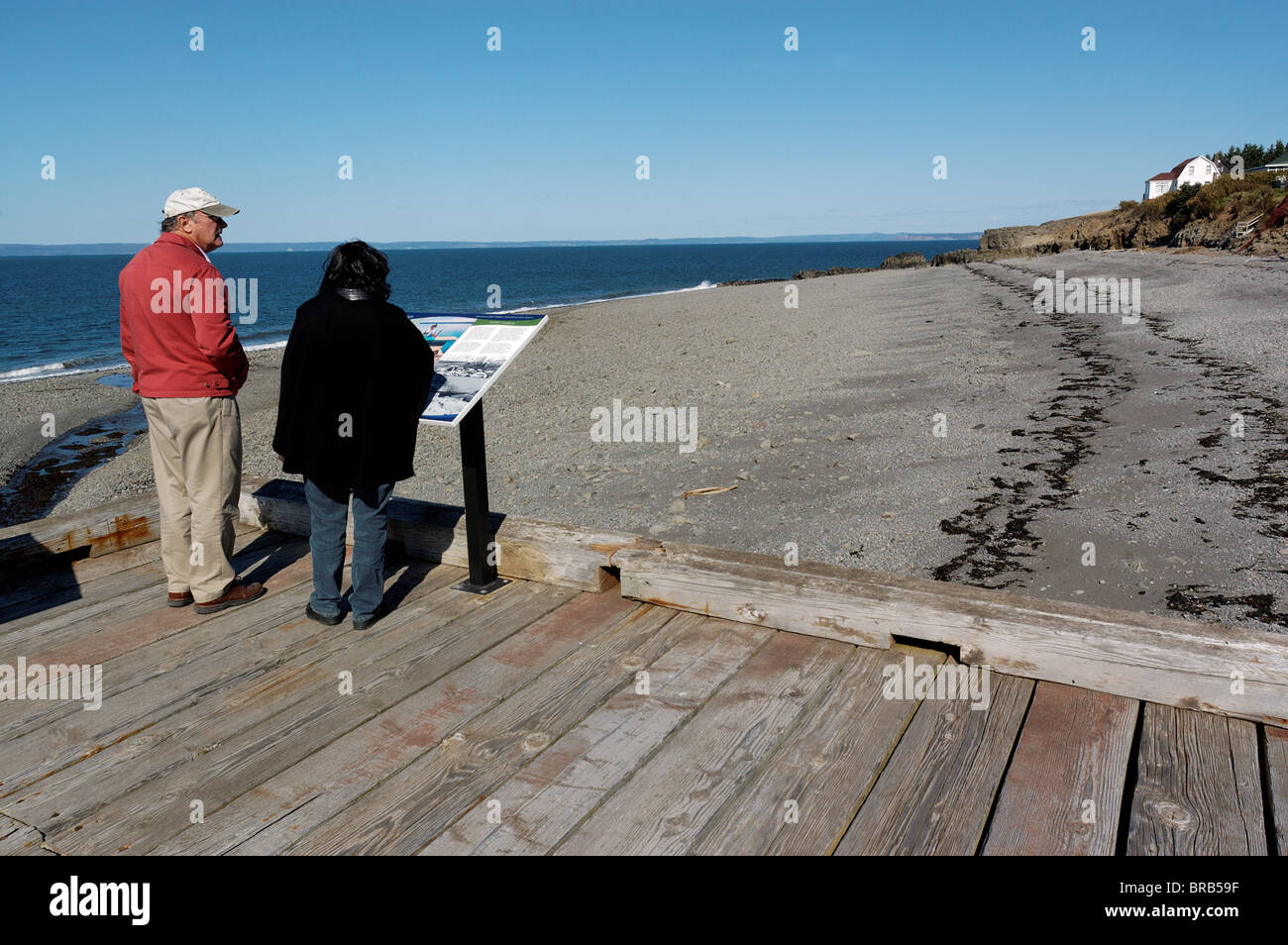 Two people looking out over the Bay of Fundy, home of the world's highest tides Stock Photo