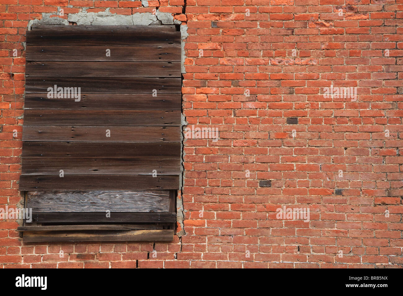 Old brick wall with weathered wood boarded window Stock Photo - Alamy