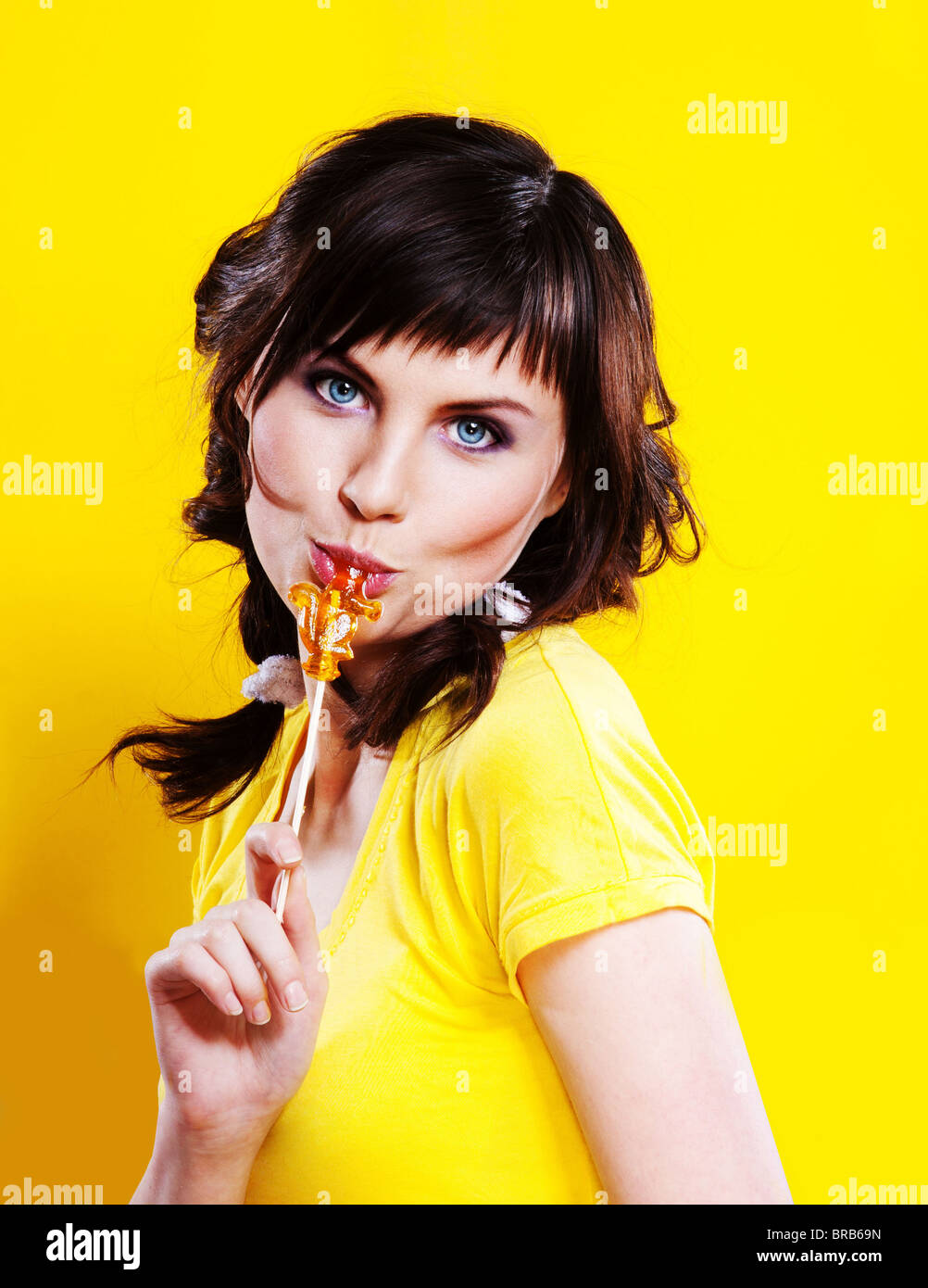 portrait of beautiful girl on yellow background Stock Photo - Alamy