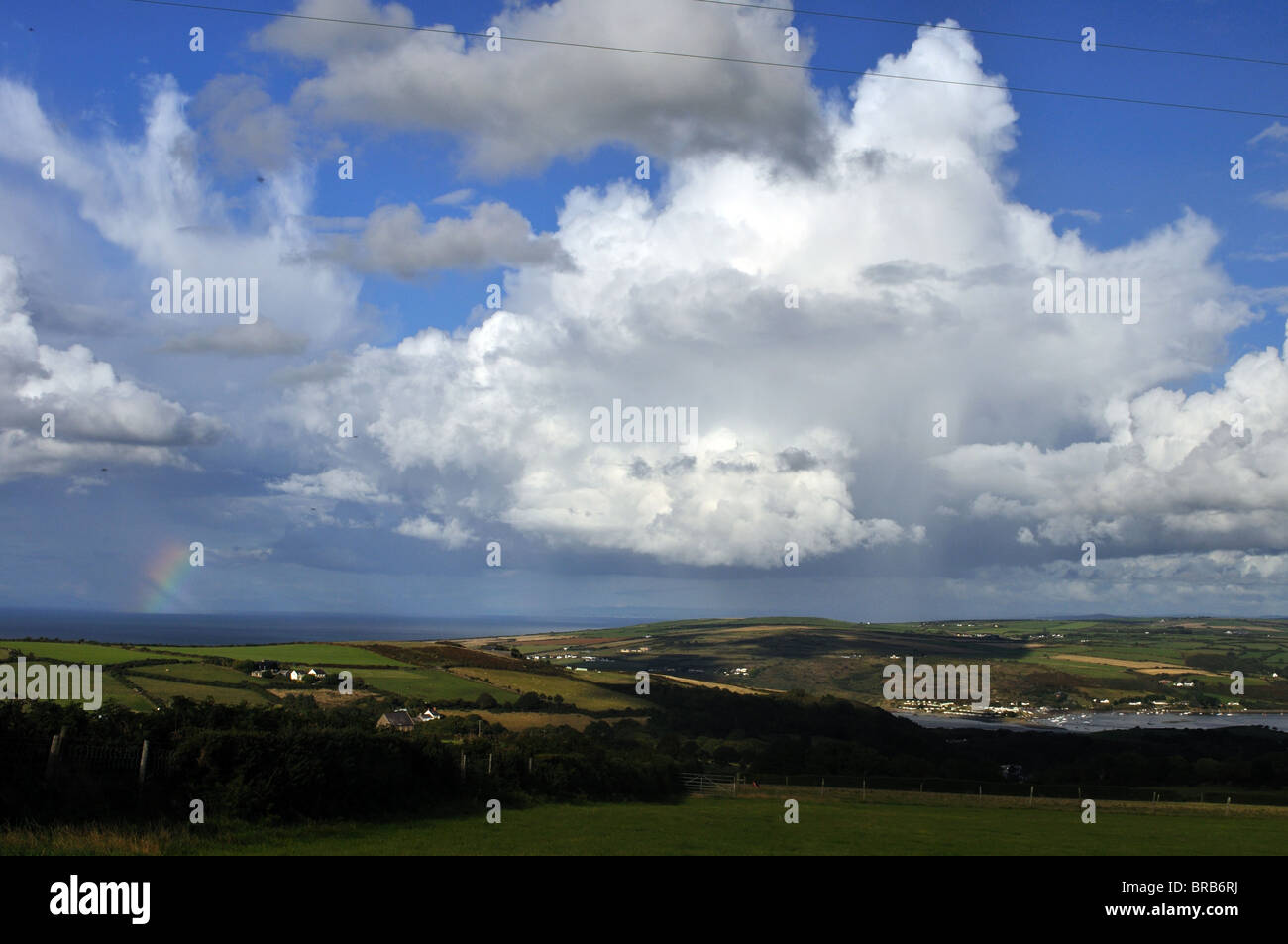 Rainbow and cumulonimbus cloud over Cardigan Bay, St Dogmaels, Pembrokeshire, Wales, United Kingdom Stock Photo
