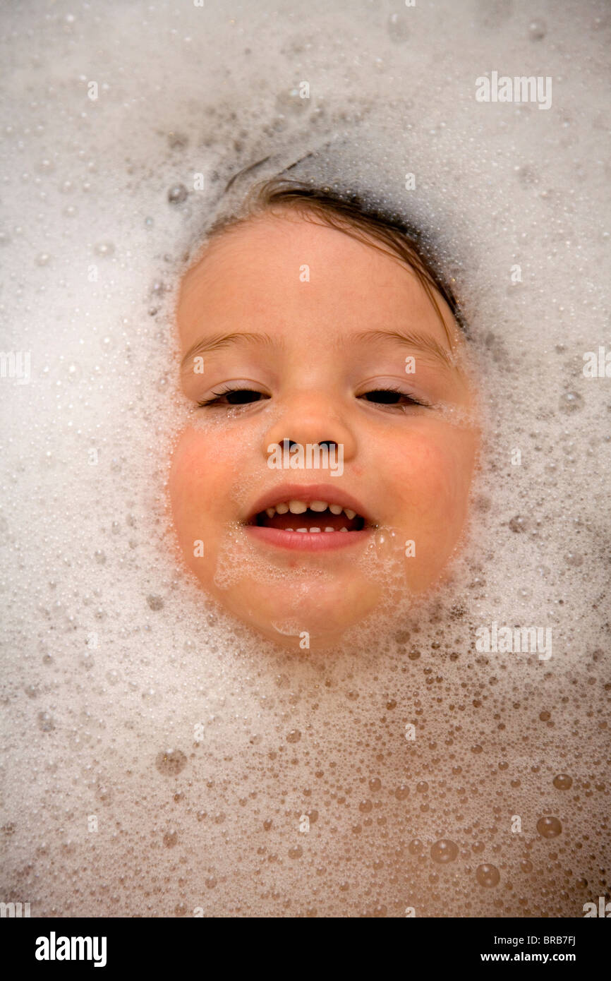2 year old boy in a bubble bath Stock Photo