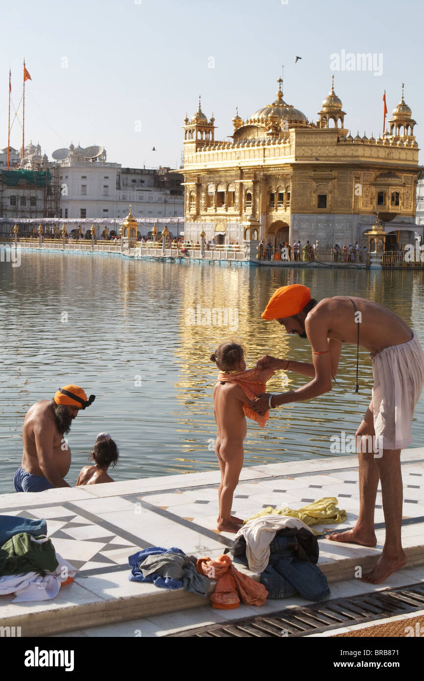 indians taking a bath at the golden temple Stock Photo