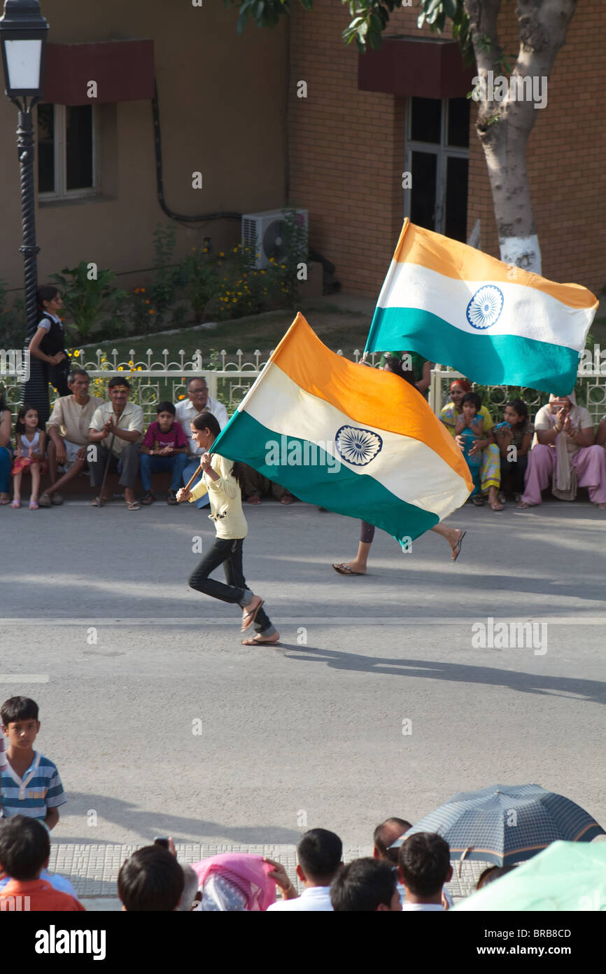 indians women running with indian flags at the Wagha border ceremony Stock Photo