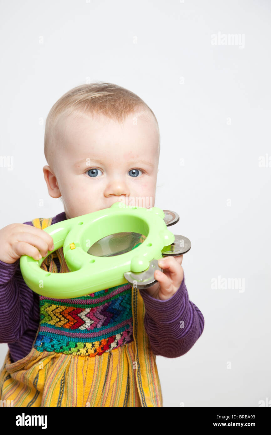Baby boy with musical toy in his mouth. Photo:Jeff Gilbert Stock Photo
