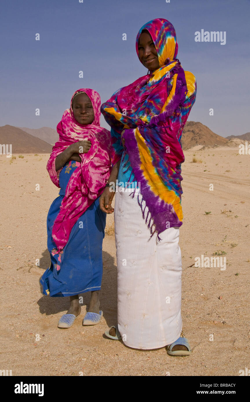 Colourfully dressed Tuareg women in the Sahara, Southern Algeria, North Africa Stock Photo