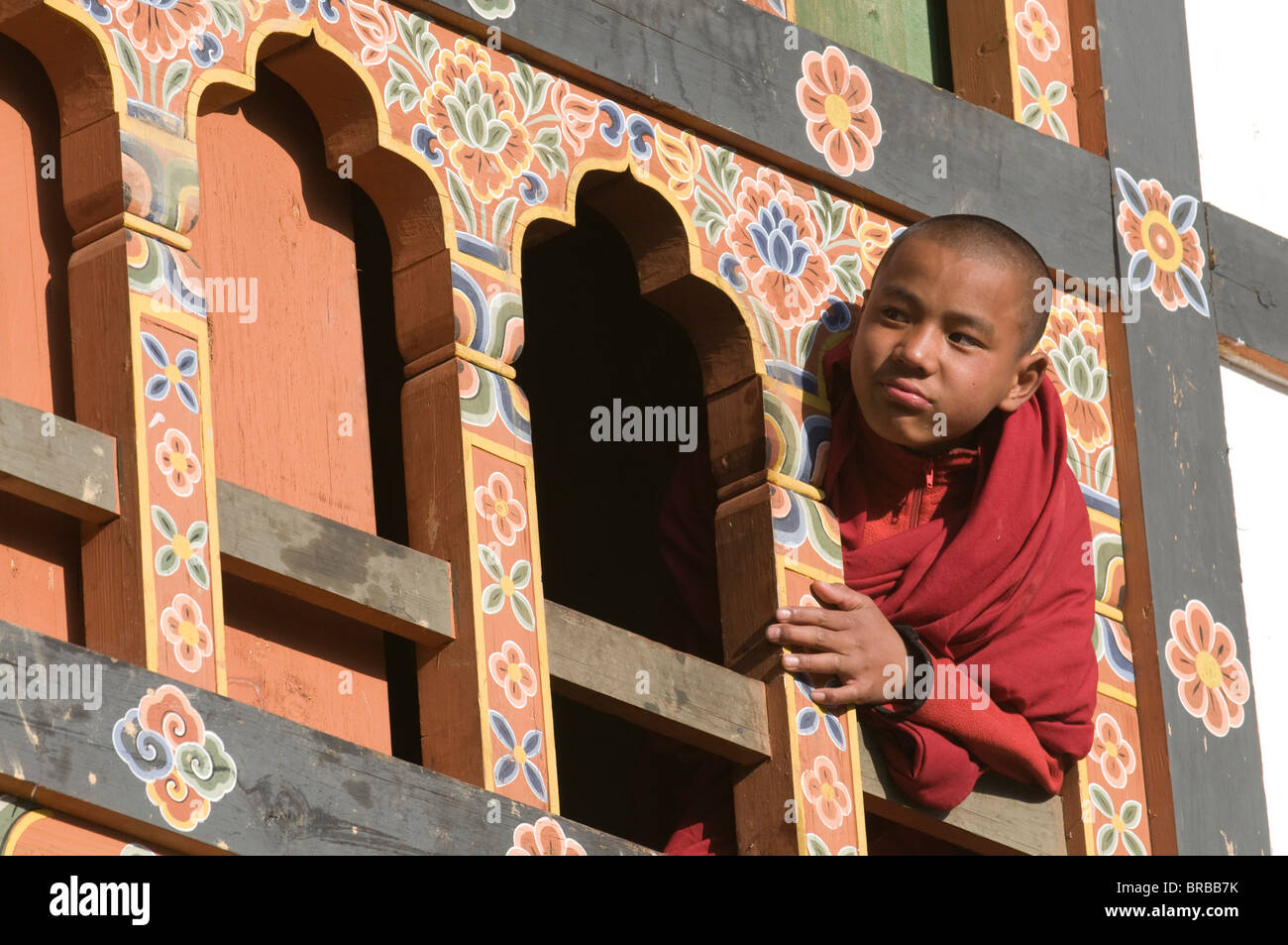 Young Buddhist monk at window, Gangte Goempa, Bhutan Stock Photo